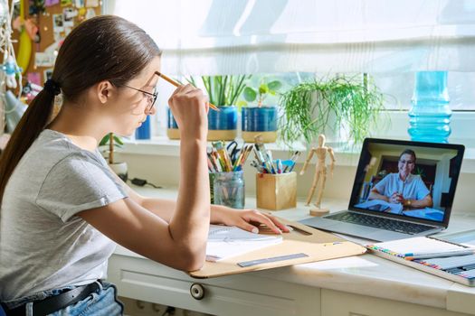 Online drawing lesson, teenage girl having video call conference chat with teacher sitting at table at home. Young creative art student. Creativity technology education e-learning adolescence concept