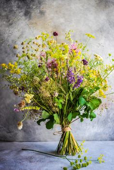 Summer wild flowers in bouquet as a gift concept in interior