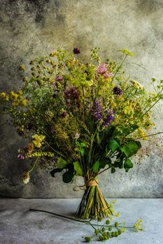 Summer wild flowers in bouquet as a gift concept in interior