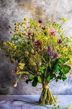 Summer wild flowers in bouquet as a gift concept in interior