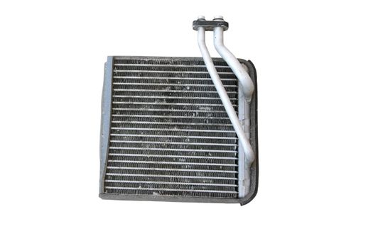 Old car radiator heater isolated on white background. Auto parts. The surface of the old engine water-cooled radiator.