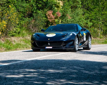 URBINO, ITALY - JUN 16 - 2022 : FERRARI TRIBUTE Ferrari 812 Superfast IN an old racing car in rally Mille Miglia 2022