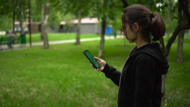 Samara, Russia - July 20, 2022: A young woman launches the stepn app and starts running. Stepan is a modern play-to-earn application on the blockchain. 4k