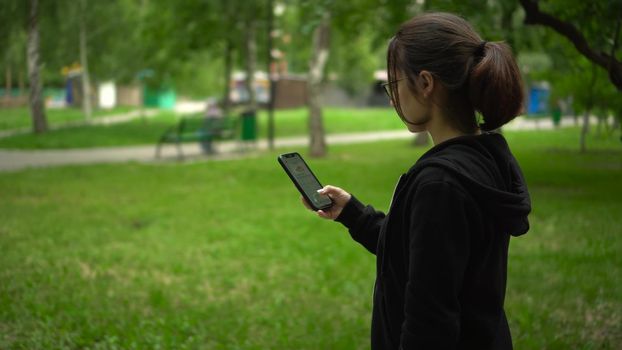 Samara, Russia - July 20, 2022: A young woman launches the stepn app and starts running. Stepan is a modern play-to-earn application on the blockchain. 4k