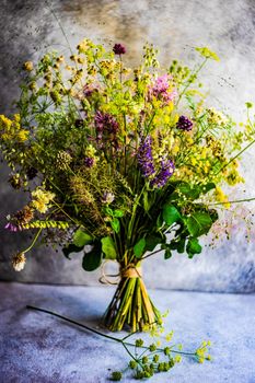 Summer wild flowers in bouquet as a gift concept in interior