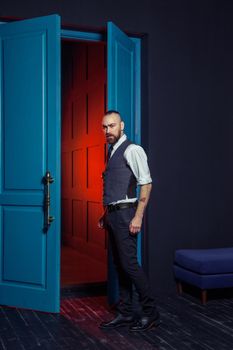 handsome fashion model man in suit model posing in the room