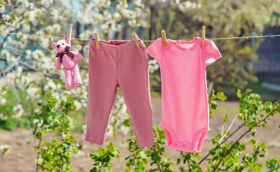 Baby clothes are drying on the street. Selective focus. nature.