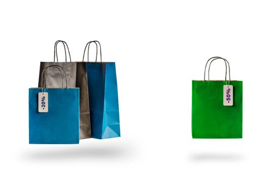 Set of multicolored shopping bags on a white isolated background. Sale and discounts 10, 20, 30, 40, 50. Packages float in the air, casting a shadow.