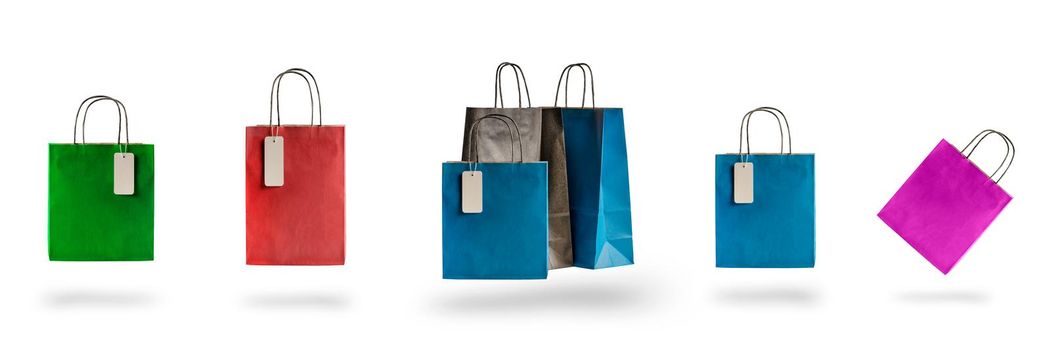 Set of multicolored shopping bags on a white isolated background. Sale and discounts 10, 20, 30, 40, 50. Packages float in the air, casting a shadow.