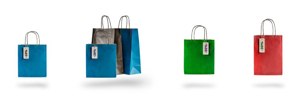 Set of multicolored shopping bags on a white isolated background. Sale and discounts 10, 20, 30, 40, 50. Packages float in the air, casting a shadow.