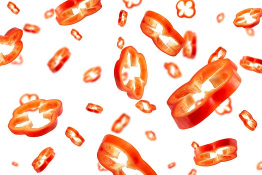 Red bell pepper cut into slices isolated on white background. Falling pepper slices in different sizes and with different directions