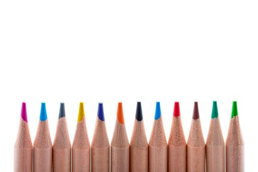 Isolate of multicolored wooden pencils. Pencils of different colors ,arranged in a rowstand out against a uniform white background, for insertion into a project or for printing a banner or label