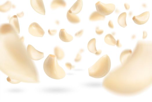 Set of peeled garlic cloves falling on a white background with selective focus. Garlic, isolated on a white background, flies down, casting a shadow
