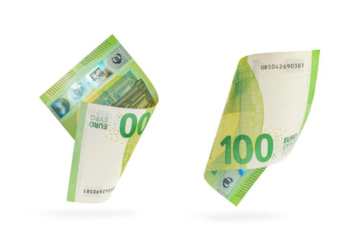 One hundred euro banknote set isolated on white background. European money folded in half, close-up of money casts a shadow
