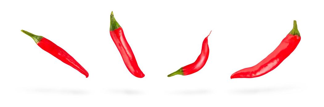 Set of red hot chili peppers. Falls, casting a shadow on a white isolated background. Organic fresh chili pepper isolated on white. Full Depth of Field.