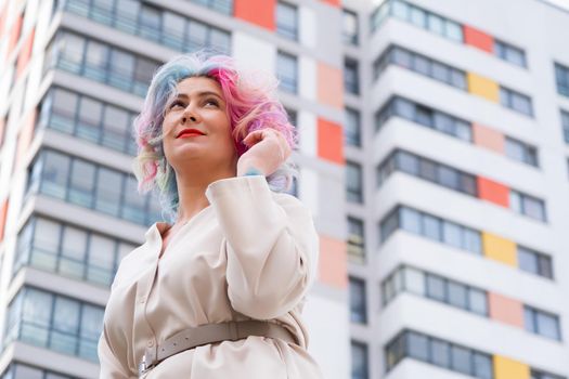 Portrait of a middle-aged woman with multi-colored hair walks on the streets of the city