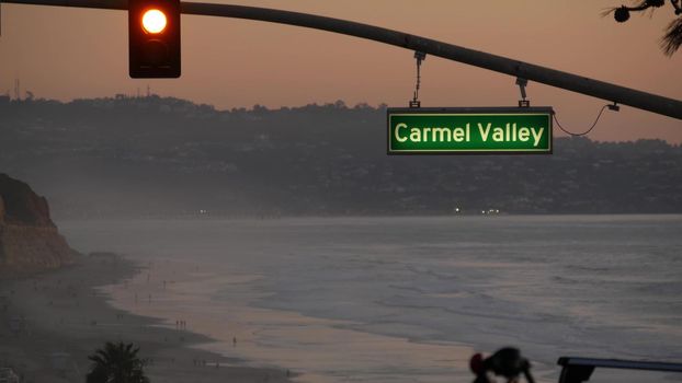 Traffic lights, pacific coast highway 1, Torrey Pines state beach, Del Mar, San Diego, California USA. Coastal road trip vacations. Roadtrip along ocean, freeway 101. Carmel Valley sign, twilight dusk