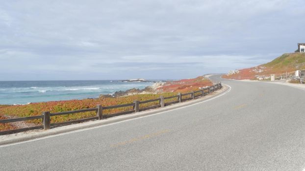 17-mile drive scenic road, Monterey California USA. Trip along ocean, sea waves. Pacific coast highway roadtrip, tourist route near Point Lobos, Big Sur and Pebble beach. Fence and succulent ice plant