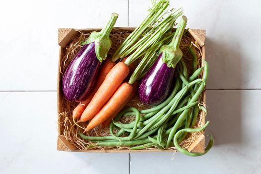 case with vegetables on the tiles background, top view