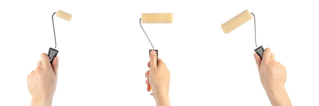 Paint roller in a man's hand. Renovation concept. Supplies and tools for painting walls isolated on white.