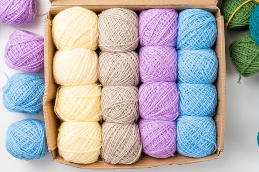 Knitting needles, colorful threads. Selection of colorful yarn wool on shopfront. Knitting background, a lot of balls. Knitting yarn for handmade winter clothes