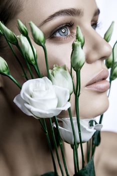 portrait of beautiful model with good skin on white background with white roses flower.