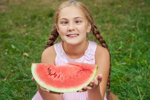 Portrait of happy girl with watermelon enjoing summer outdoor daytime.