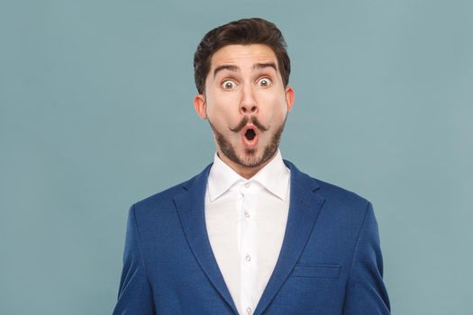 Closeup portrait of amazement manager open mouth and big eyes. Business people concept, richly and success. Indoor, studio shot on light blue background