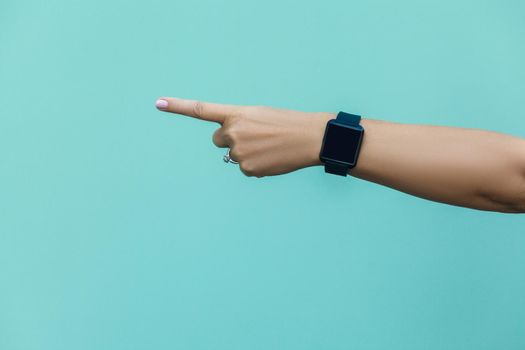 Look this! Hand finger pointing isolated on light blue background.
