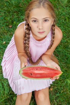 Portrait of happy girl with watermelon enjoing summer outdoor daytime.
