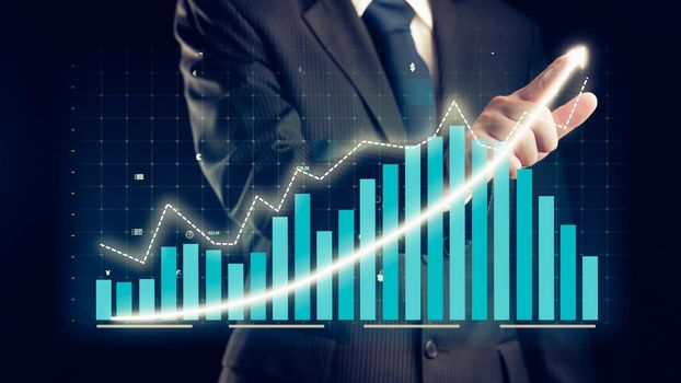 Businessman draw finance allusive graph chart showing business profit growth increasing to future target . Excellent financial status of corporate business rise up . Finance and money technology .
