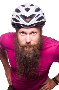 funny happy european bearded cyclist wearing helmet with pink or purple t shirt. advise people to protection. studio shot. isolated on white.