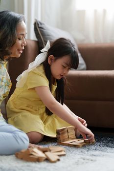 Happy moment of Daughter enjoying time together with mother at home. little child girl having fun