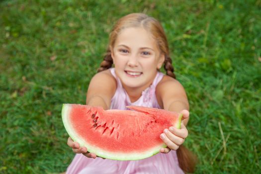 Portrait of happy girl with watermelon enjoing summer outdoor daytime.