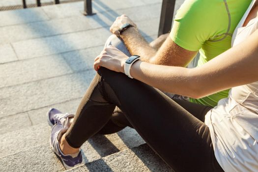 Two people using smart sport watch at workout.