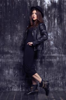Portrait of beautiful woman model in dark dress posing and looking.
