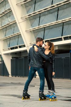 Beautiful roller skater couple with hipster style skating after the rain.