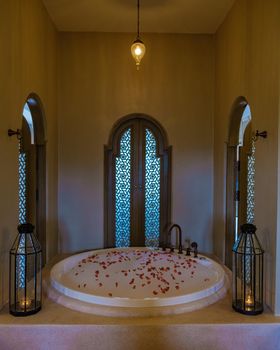 romantic bathtub with rose petals, luxury vacation in a jacuzzi. beautiful baththub