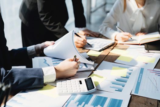 Planning to reduce investment risks, the image of a group of businesspeople working with partners is adjusting marketing strategies to analyze profitable and targeted customer needs at meetings.