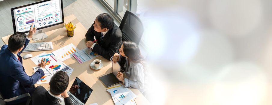 Smart businessman and businesswoman talking discussion in widen group meeting at office table in a modern office interior. Business collaboration strategic planning and brainstorming of coworkers.