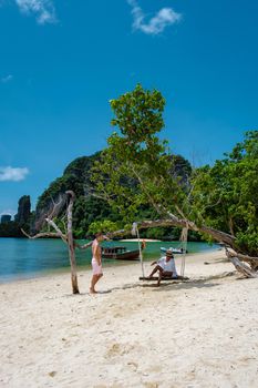 Koh Phakbia Island is near Koh Hong Krabi, a beautiful white sandy beach in Krabi Thailand. Young Asian woman and European men on the beach.