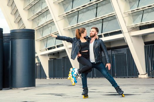 Beautiful roller skater couple with hipster style skating after the rain.