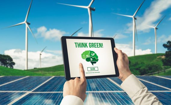Green business transformation for environment saving and ESG business concept. Businessman using tablet to set corporate goal toward environmental friendly management and alternative clean energy use.