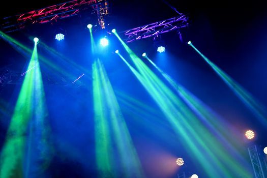 Crowd at concert - Cheering crowd in bright colorful stage lights