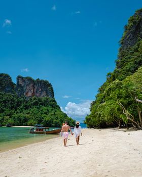 Koh Phakbia Island is near Koh Hong Krabi, a beautiful white sandy beach in Krabi Thailand. Young Asian woman and European men on the beach.