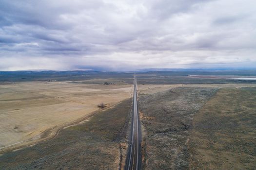 Aerial view of a country highway with clouds in the sky