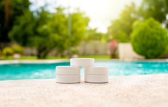 Chlorine tablets for swimming pool cleaning, close up of chlorine tablets on the edge of a swimming pool, chlorine tablets for swimming pool disinfection