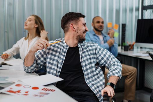 Two entrepreneurs man and woman sitting together working in an office, close up