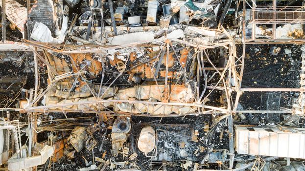 Aerial view looking down at an industrial building that has been destroyed by fire