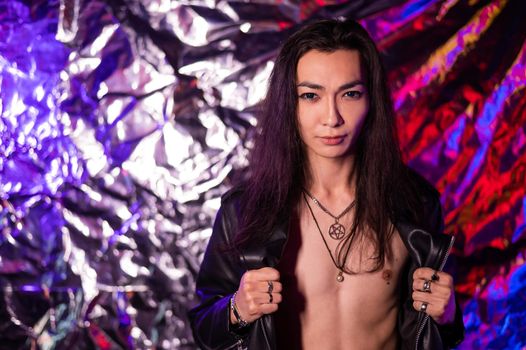 Portrait of a transgender model in a studio with neon lighting